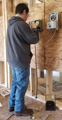 A student in the Electrical Occupations program at HCCTC works on a wiring project.