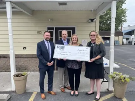 representatives pictured holding large check