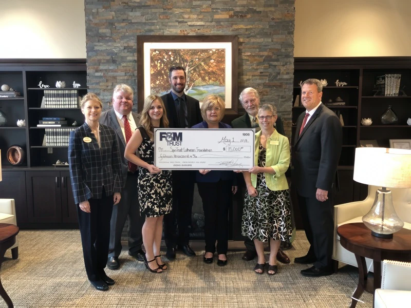 FMT and SpiriTrust Lutheran representatives with large donation check