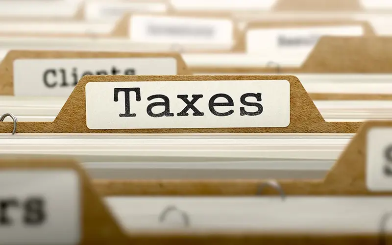 tab of a folder in a file cabinet that reads Taxes